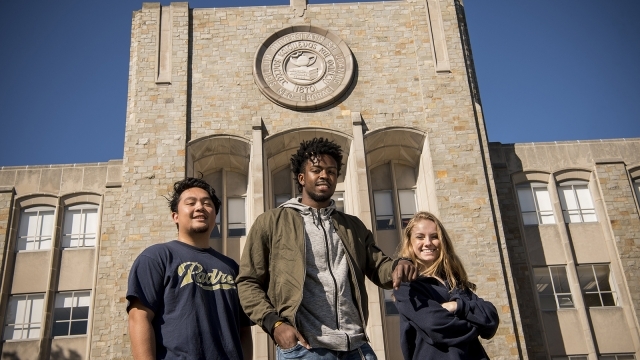 Students standing in front of library